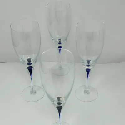 Sale Photo Thumbnail #206: Set of four modern clear wine glasses with cobalt blue accents in the stems.