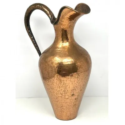 Sale Photo Thumbnail #209: Hand-hammered copper pitcher featuring a flared spout, high curved handle, and a polished finish with minor age-appropriate patina.