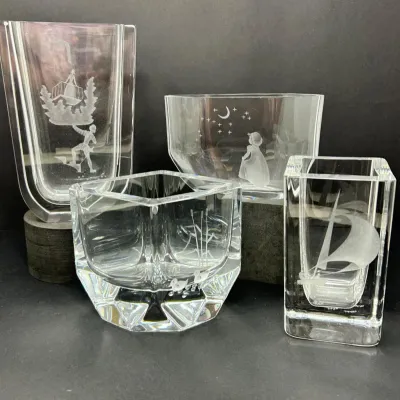 Sale Photo Thumbnail #60: Set of four Scandinavian etched crystal art glass pieces, featuring various whimsical and natural motifs including a sailboat, figures under a night sky, and waterfowl.