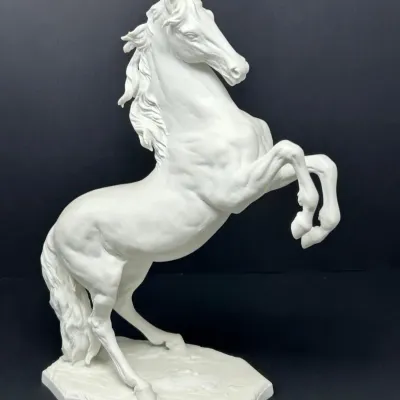 Sale Photo Thumbnail #32: White porcelain or bisque figure of a rearing stallion on a contoured base.