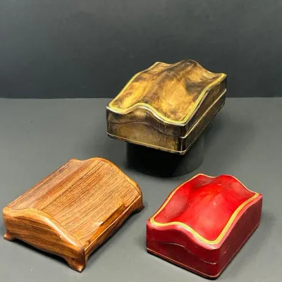Sale Photo Thumbnail #162: Set of three vintage contorted wood and gilt-accented leather jewelry or trinket boxes in various finishes.