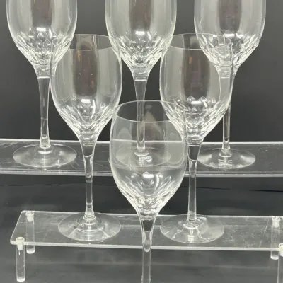 Sale Photo Thumbnail #81: Set of six crystal wine glasses featuring a cross-cut diamond pattern near the base of the bowl and long, slender stems.
