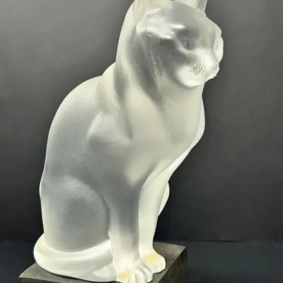 Sale Photo Thumbnail #18: Lalique-style frosted crystal or glass figure of a seated cat, displayed on a square pedestal.