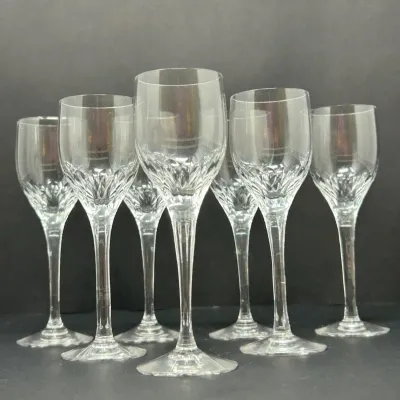 Sale Photo Thumbnail #84: Set of six cut crystal wine glasses featuring an intricate cross-cut patterned bowl and slender multi-faceted stems.