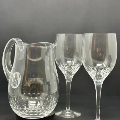 Sale Photo Thumbnail #134: Clear crystal beverage set featuring a small pitcher with an ice lip and two matching wine glasses with diamond-cut patterned bases.