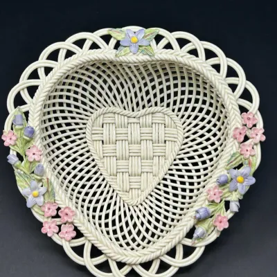 Sale Photo Thumbnail #154: Heart-shaped ceramic woven lattice basket with applied pastel floral embellishments.