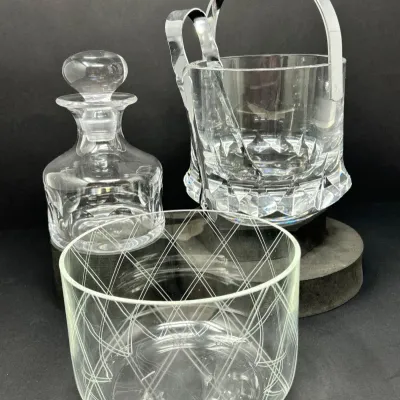 Sale Photo Thumbnail #132: Crystal barware group including a Neiman Marcus etched glass bowl, a cut crystal decanter with stopper, and a lead crystal ice bucket with metal handle and tongs.