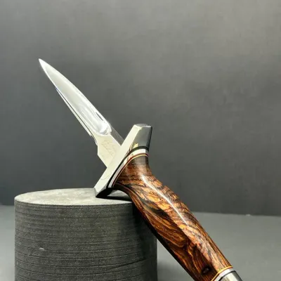 Sale Photo Thumbnail #23: Custom fixed-blade boot knife featuring a polished double-edged blade, stainless crossguard, and a contoured figured wood handle.