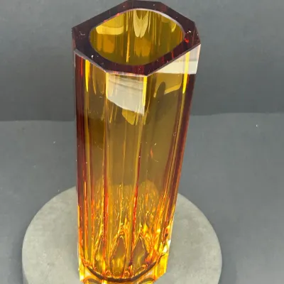 Sale Photo Thumbnail #20: Tall amber glass vase featuring a faceted octagonal design and deep reddish-orange accent along the rim.