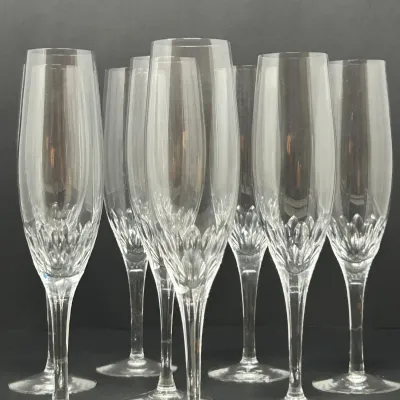 Sale Photo Thumbnail #82: Set of crystal champagne flutes featuring a cut-glass leaf design near the base of each bowl.