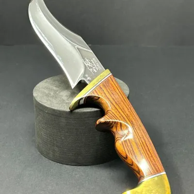 Sale Photo Thumbnail #19: Custom fixed-blade hunting knife by Davis Knives with an etched stainless steel blade, brass guard, brass pommel, and finger-grooved wood handle.