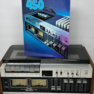 Sale Photo Thumbnail #17: Vintage TEAC 450 stereo cassette deck with original promotional product brochure, featuring dual VU meters and wood cabinet casing.