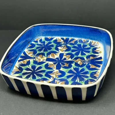 Sale Photo Thumbnail #13: Vintage Scandinavian modern ceramic dish featuring a hand-painted blue floral interior pattern and a striped exterior border.