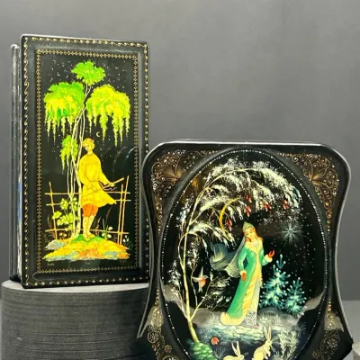 Sale Photo Thumbnail #166: Pair of Russian lacquer trinket boxes with hand-painted fairytale miniature illustrations on black backgrounds, bordered in gold scrollwork.