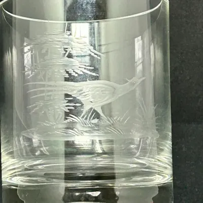 Sale Photo Thumbnail #92: Vintage clear crystal rocks glass featuring an etched wildlife scene of a pheasant in a landscape, with a heavy base.