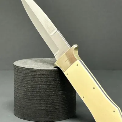 Sale Photo Thumbnail #42: Custom double-edged fixed blade boot knife stamped Ankrom, featuring off-white scales and a satin finish blade.