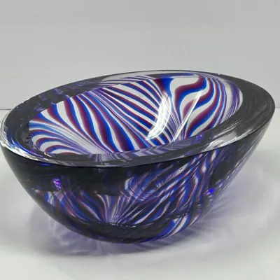 Sale Photo Thumbnail #142: Heavy Murano-style sommerso art glass bowl featuring swirling blue, purple, and white ribbons encased in clear glass.