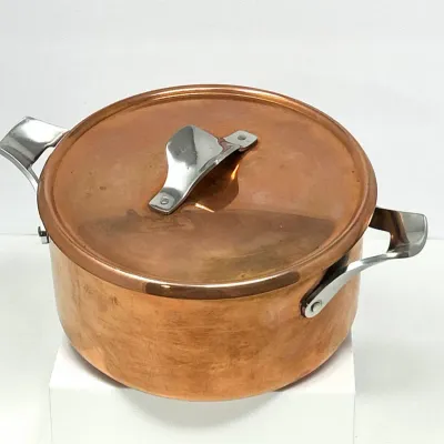 Sale Photo Thumbnail #27: Polished copper stockpot with matching lid, featuring riveted stainless steel handles and a fitted top.