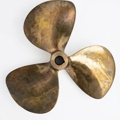 Sale Photo Thumbnail #62: Vintage three-blade bronze boat propeller featuring an aged patina and a keyed center bore.