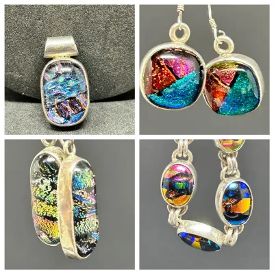 Sale Photo Thumbnail #136: Collection of artisan dichroic glass jewelry set in silver, including pendants, drop earrings, and a link bracelet with vibrant iridescent mosaic patterns.