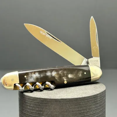 Sale Photo Thumbnail #192: Vintage E. Bruckmann Solingen multi-tool folding pocket knife featuring two blades, a corkscrew, and dark horn handles with nickel silver bolsters.
