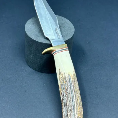 Sale Photo Thumbnail #156: Randall Made fixed blade knife featuring a stag horn handle, brass guard, and signature Orlando, Florida blade stamp.