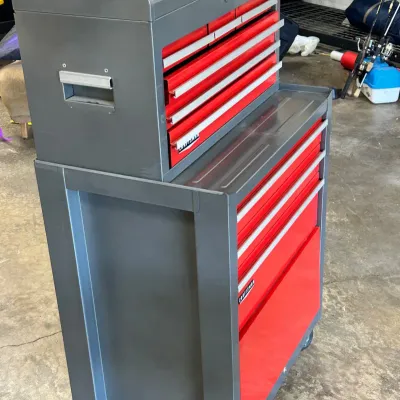 Sale Photo Thumbnail #114: Two-piece Craftsman rolling tool chest combo in gray and red finish, featuring a multi-drawer top chest seated on a mobile lower cabinet.