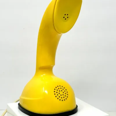 Sale Photo Thumbnail #205: Vintage yellow Ericofon cobra telephone by Ericsson, featuring a classic mid-century modern design with a built-in base dial.