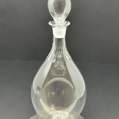 Sale Photo Thumbnail #86: Vintage clear glass decanter featuring a teardrop-shaped body, subtle facet-cut accents on the neck, and a solid teardrop glass stopper.