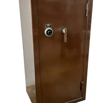 Sale Photo Thumbnail #216: Tall brown metal gun or security safe featuring a combination dial lock and vertical handle.
