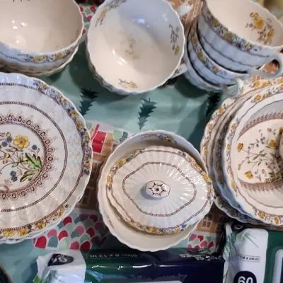 Sale Photo Thumbnail #40: SPODE BUTTERCUP Vintage ceramic tea set featuring yellow and purple floral patterns with scalloped edges, including teacups, saucers, plates, a cream pitcher, and a covered bowl.