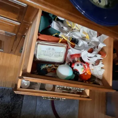 Sale Photo Thumbnail #36: Open wooden dresser drawer containing various small trinkets, ribbons, and decorative items.