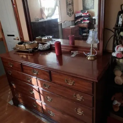 Sale Photo Thumbnail #89: Traditional dark wood nine-drawer dresser with brass swan-neck pulls and attached large framed mirror with top shelf.