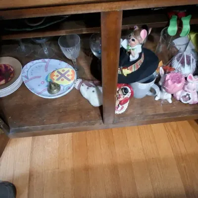Sale Photo Thumbnail #35: Wooden cabinet filled with assorted glassware, decorative plates, and holiday figurines.