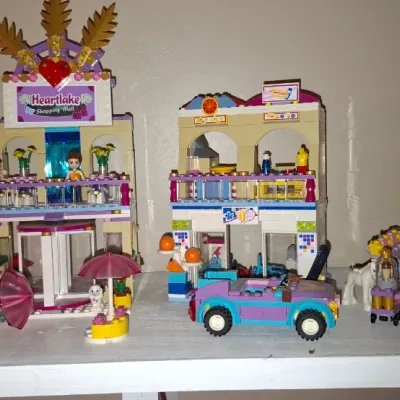 Sale Photo Thumbnail #125: Assembled Lego Friends Heartlake Shopping Mall set including multiple building sections, minidolls, and a convertible car.