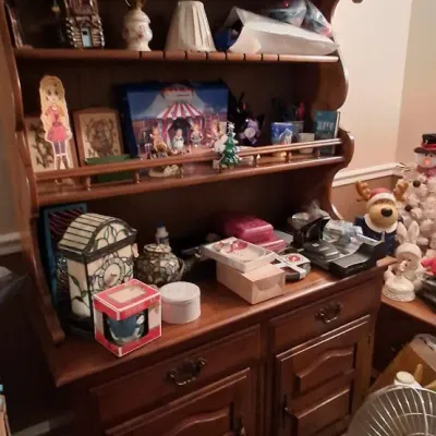 Sale Photo Thumbnail #114: Vintage Colonial-style dark wood hutch with scalloped trim and lower cabinet storage, displayed with various knickknacks and decor items.