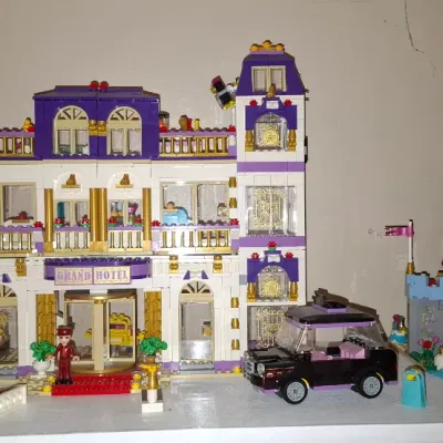 Sale Photo Thumbnail #127: Assembled Lego Friends Heartlake Grand Hotel (41101) and Disney Princess Cinderella's Romantic Castle (41055) playsets, displayed with accessories and mini-doll figures.