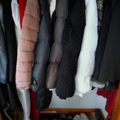 Sale Photo Thumbnail #92: Closet filled with assorted winter coats, jackets, and footwear including sneakers and sandals.