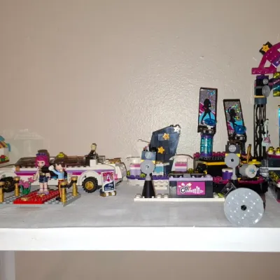 Sale Photo Thumbnail #120: Collection of assembled Lego Friends Pop Star themed sets, including a performance stage, limo, tour bus, and various mini-doll figures.