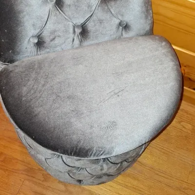 Sale Photo Thumbnail #4: Tufted grey velvet vanity chair with a curved backrest, featuring button detailing on both the back and base.