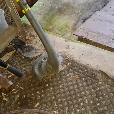 Sale Photo Thumbnail #138: Collection of outdoor and hand tools including long-handled loppers, a Ryobi weed trimmer, and a mallet on a shop floor.