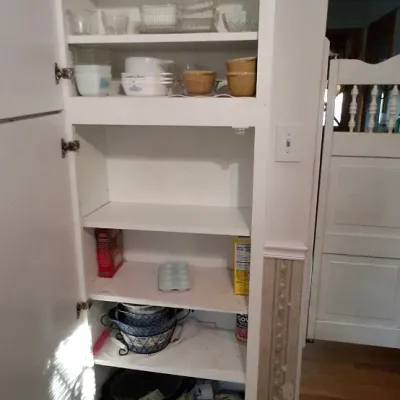 Sale Photo Thumbnail #50: Tall white pantry cabinet filled with vintage glassware, CorningWare baking dishes, ceramic crocks, and kitchen small appliances.