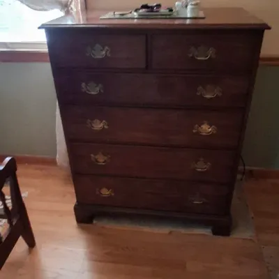 Sale Photo Thumbnail #91: Traditional dark wood tallboy chest of drawers featuring brass swan-neck bail handles and bracket feet.