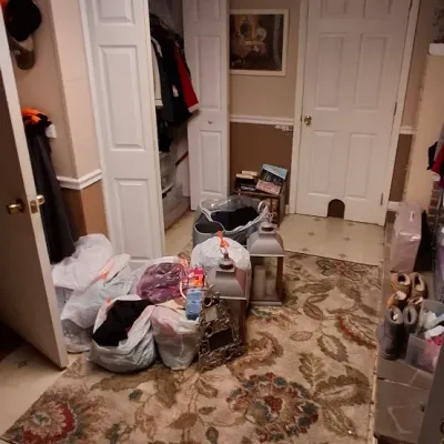 Sale Photo Thumbnail #61: Assorted household items, including a large floral area rug, decorative lanterns, framed artwork, and various bags of clothing.