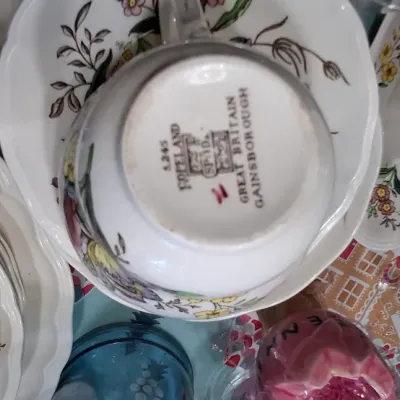 Sale Photo Thumbnail #38: Collection of Spode "Gainsborough" pattern fine china dishes, including teacups, saucers, stack of plates, and a creamer jug.