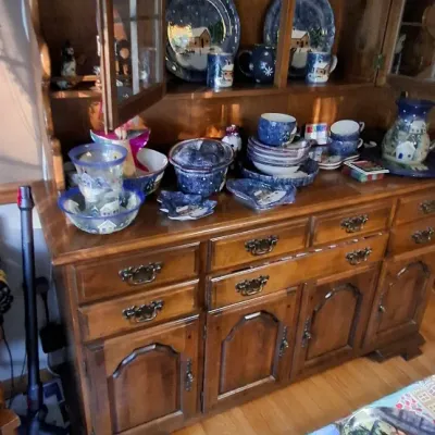 Sale Photo Thumbnail #37: Large wooden china hutch filled with winter scene dinnerware and mugs.