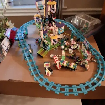 Sale Photo Thumbnail #112: Assembled LEGO Friends Amusement Park Roller Coaster set featuring a teal track layout and Ferris wheel attraction.