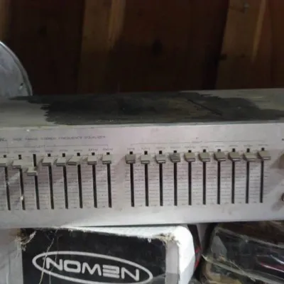 Realistic wide-range stereo frequency equalizer with dual-channel slider controls and silver-tone metal faceplate, circa 1980s.