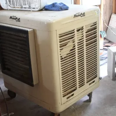 Mobile MasterCool portable evaporative cooler on caster wheels, showing light wear and surface dirt.