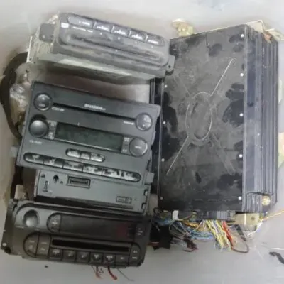 Assortment of vintage car audio components, including a Shaker head unit, aftermarket stereo decks, and a power amplifier.